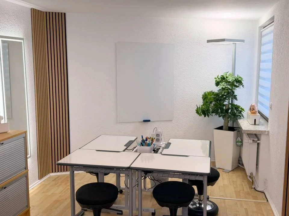 Zweiter Lernraum von INGkids mit Gruppentisch und Whiteboard